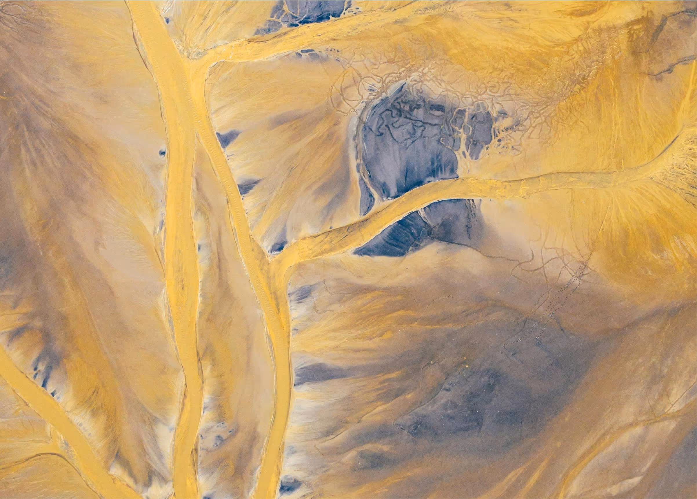 Abstract yellow and blue landscape with fluid shapes, suggesting movement and the emotional impact of menstrual flow.