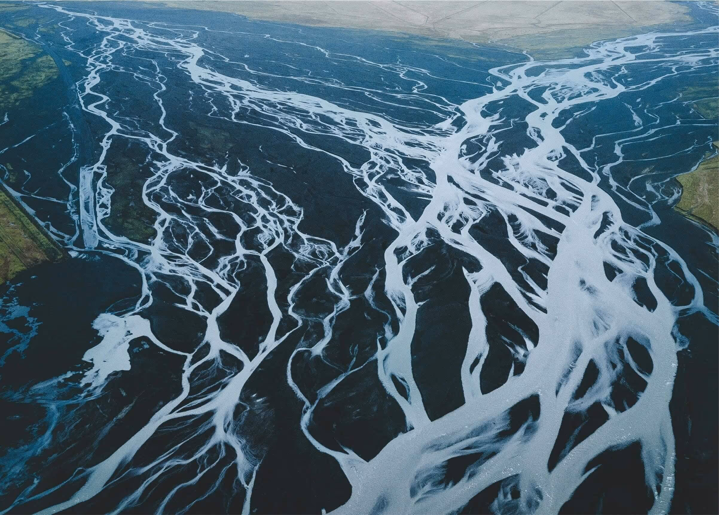 Icelandic landscape showing multiple rivers converging and splitting, representing family ties, genetics, and the flow of inherited traits.