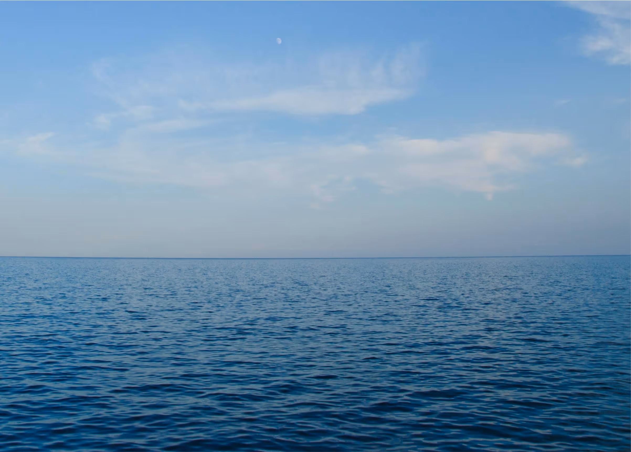 Vast ocean view with seamless horizon of water and sky, symbolizing continuity, connection, and expanding awareness.