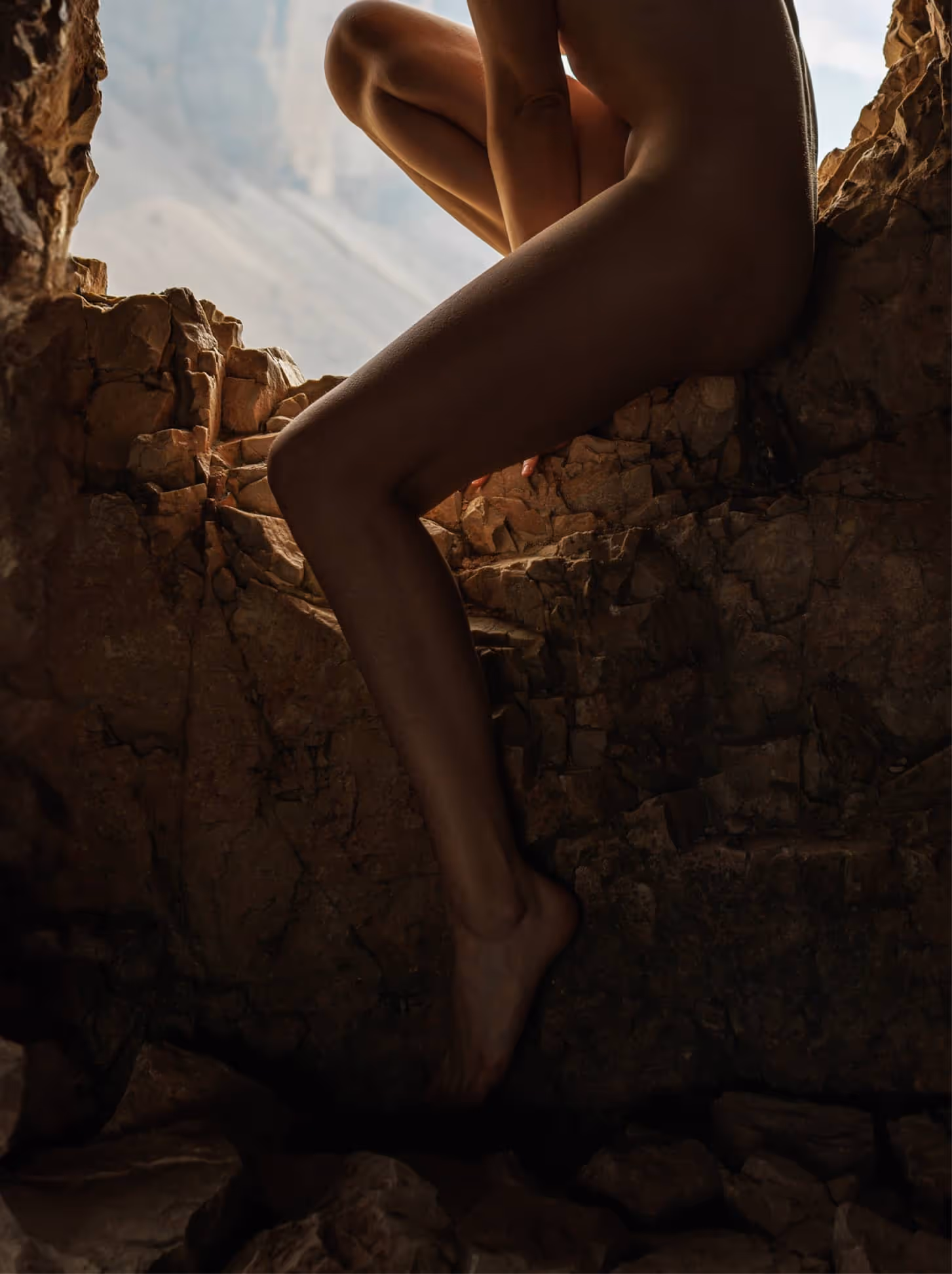 Woman’s leg stepping on rocky terrain inside a cave, symbolizing courage and the first step in taking a leap forward despite risks.
